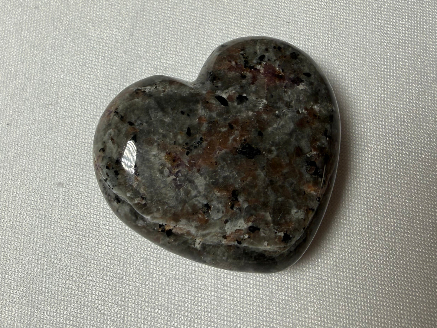 Heart-shaped stone on a light gray background